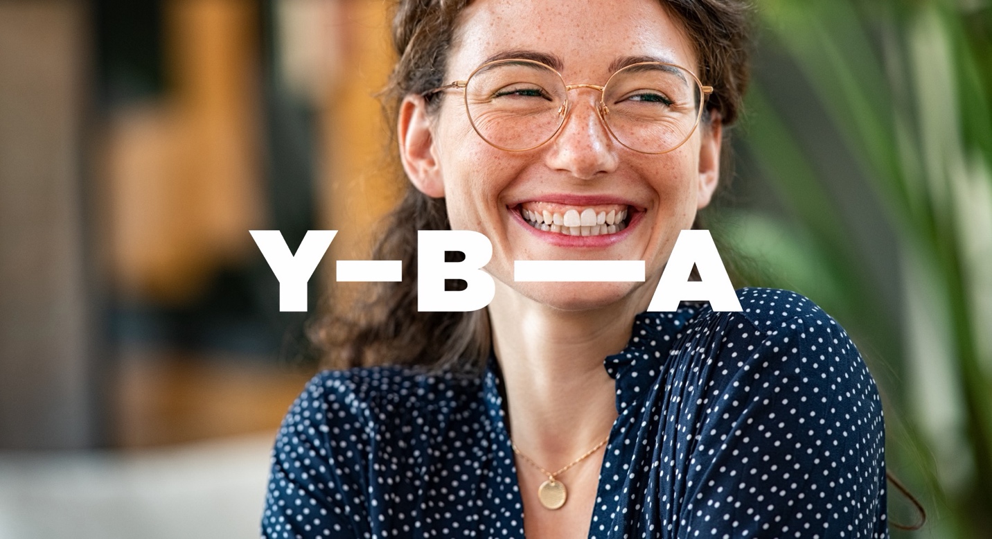The wordmark in white over a photograph of a smiling YBA member