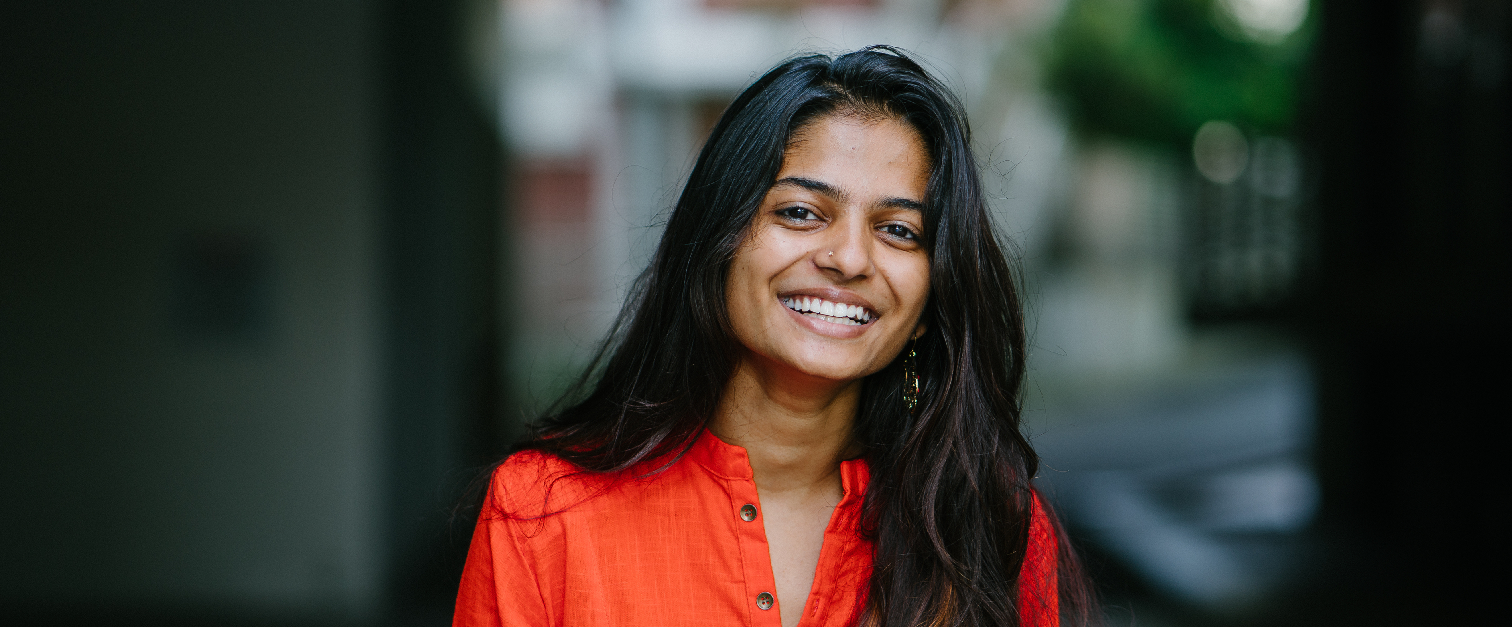 A smiling YBA Ambassador outside an office