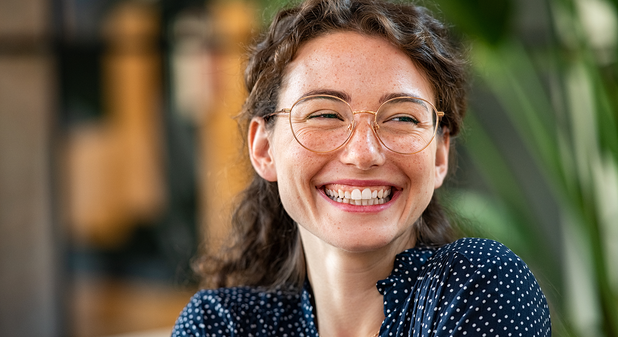 A young business analyst smiling at a networking event