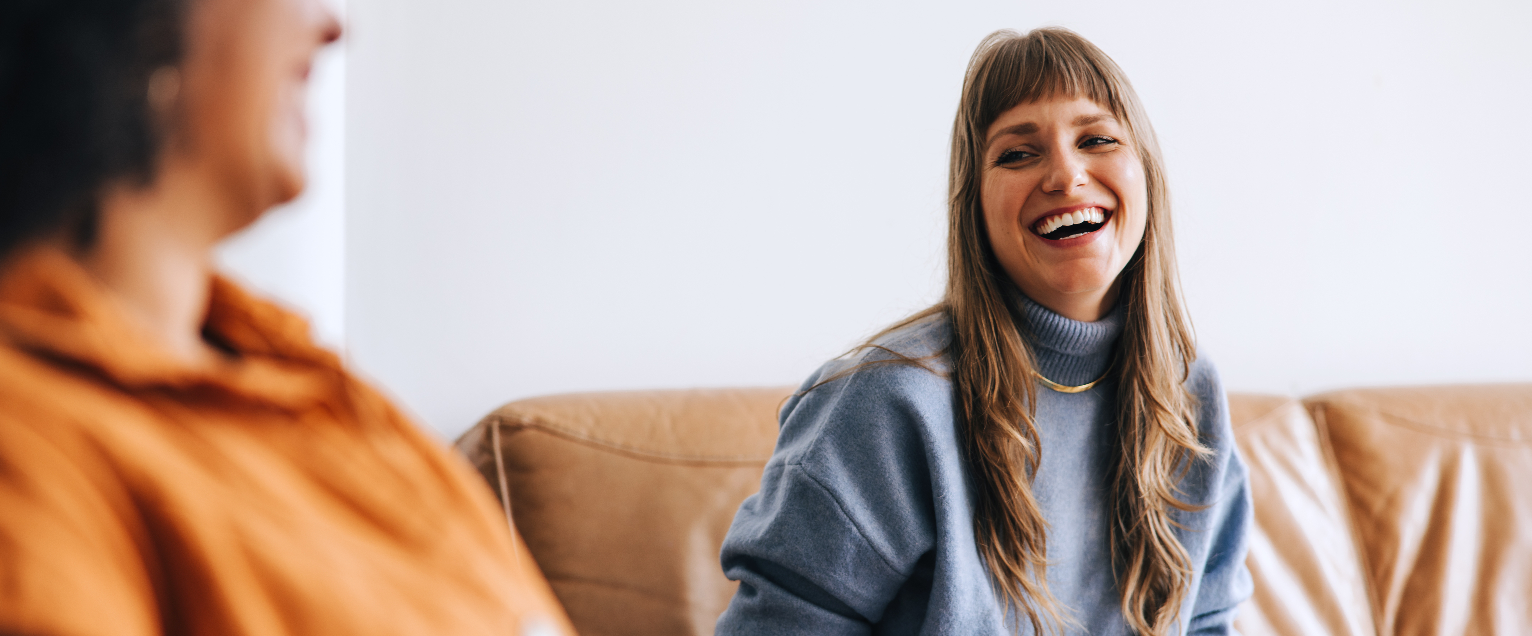 Two YBA members laughing together during a conversation