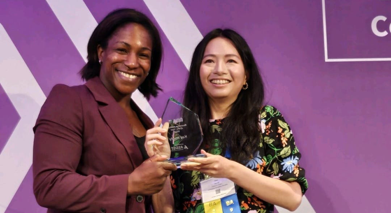 Two YBA members receiving an award on stage